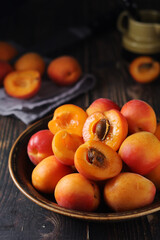 Fresh ripe apricots in bowl in rustic style	