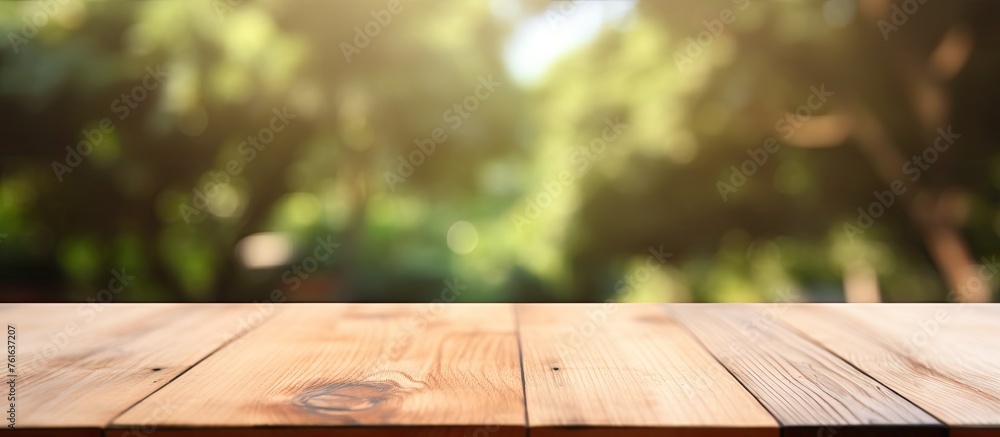 Poster a hardwood table set on a grassy surface with blurred trees in the background, creating a natural an
