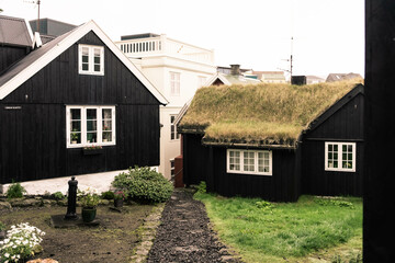 Fototapeta na wymiar Nice street of Torshvan in Faroe Islands with black houses and grass on the roofs - Streymoy, Faroe Islands
