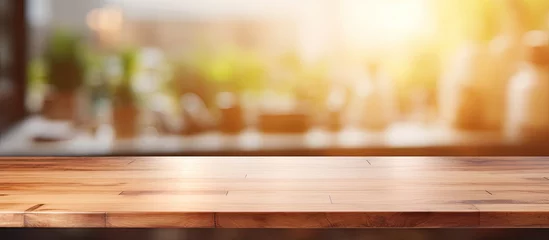 Foto op Canvas A hardwood rectangular table in the foreground with amber tints and shades. Blurry natural landscape background with grass, horizon, and wood flooring © AkuAku