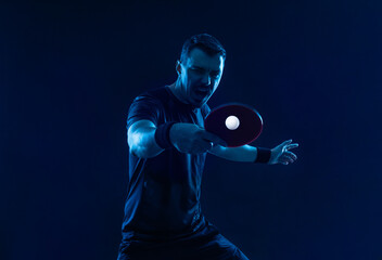 Table tennis player on the black background. Ping pong banner. Download a photo of a table tennis player for a tenis racket packaging design. Image for tennis ball box template. - 761643683