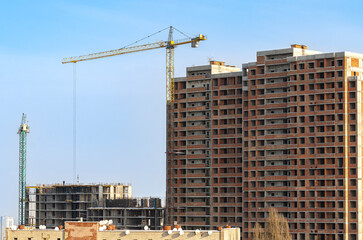Fototapeta na wymiar Cranes. Construction of a multi-storey residential building.