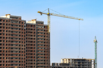 Fototapeta na wymiar Cranes. Construction of a multi-storey residential building.