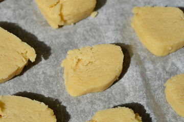 Unbaked butter cookies on parchment paper