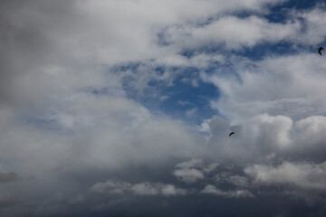 Cloudy sky with white clouds and a cloudless area with blue sky