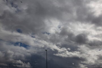 Cloudy sky with white clouds and a cloudless area with blue sky