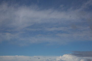 Cloudy sky with white clouds and a cloudless area with blue sky