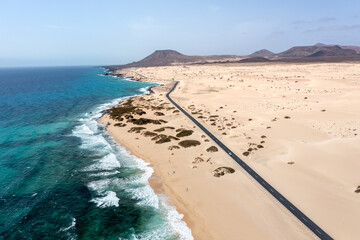 Panoramic high angle aerial drone view of Corralejo National Park (Parque Natural de Corralejo) with sand dunes located in the northeast corner of the island of Fuerteventura, Canary Islands, Spain