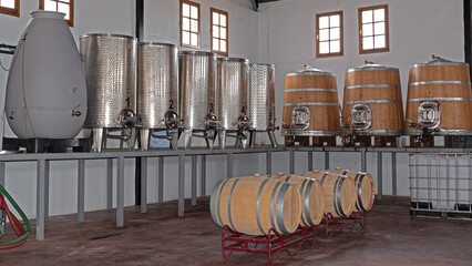 wooden, ceramic and metal vats for wine from the winery