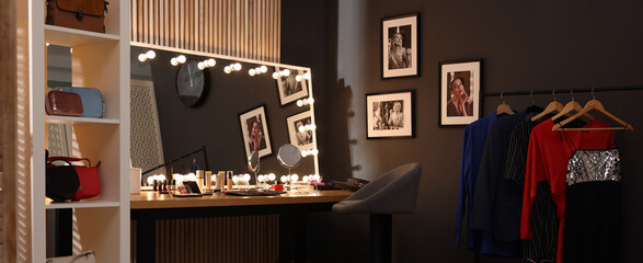 Makeup room. Dressing table with mirror, clothing rack and chair indoors, banner design