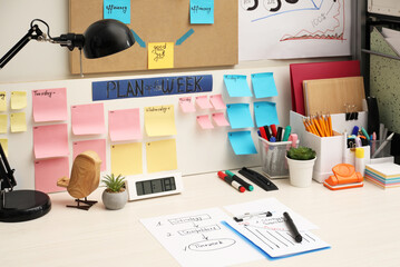 Business process planning and optimization. Workplace with lamp, colorful paper notes and other...