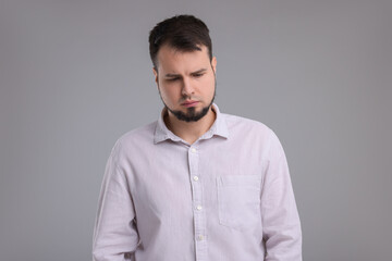 Portrait of sad man on grey background