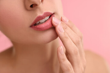 Obraz na płótnie Canvas Woman with beautiful lips on pink background, closeup
