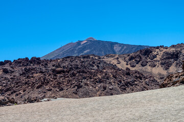 View of Teide volcano and the caldera ridge in behind the pumice and lava fields, Teide National Park, Tenerife, Spain