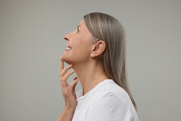 Fototapeta premium Beautiful woman with healthy skin on grey background