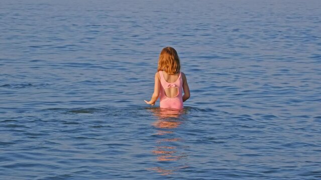 Unsupervised Young Caucasian Kid Girl Walking Alone into Sea