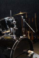 Fototapeta na wymiar Part of a drum kit with cymbals in a music studio, on stage. Background for photos with live music, rock. Vertical photo
