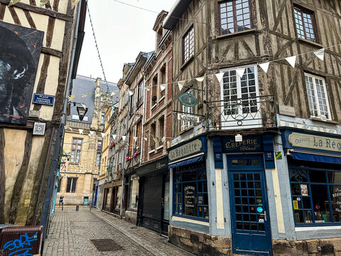 Rouen, France - 18.02.2024. Medieval street view of historical center of Rouen with half-timbered houses, Normandy, France. Downtown street view with fachwerk houses on a rainy winter day