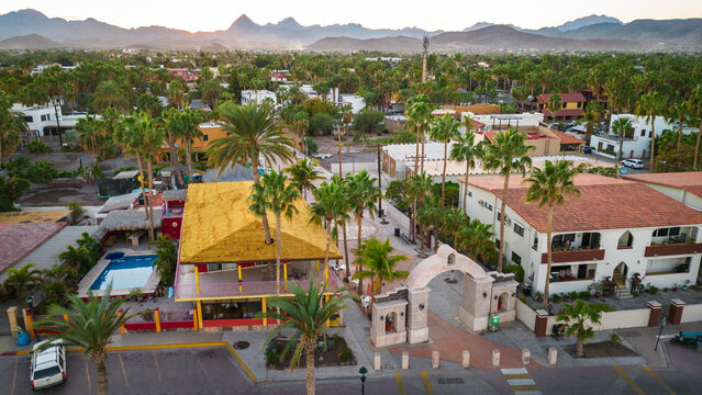 drone fly above Loreto Baja California Sur Mexico old colonial town with sea gulf ocean and mountains desert landscape at sunset