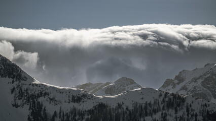 strong south wind and foehn clouds in the alps at a sunny spring day in the national park hohe tauern in austria