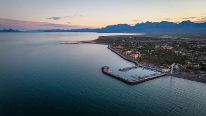 Foto auf Leinwand drone fly above Loreto Baja California Sur Mexico old colonial town with sea gulf ocean and mountains desert landscape at sunset © Michele