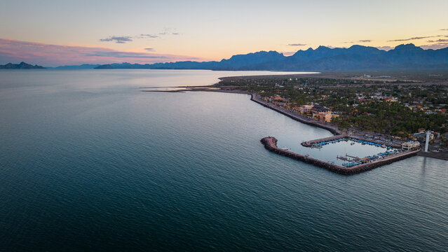 drone fly above Loreto Baja California Sur Mexico old colonial town with sea gulf ocean and mountains desert landscape at sunset