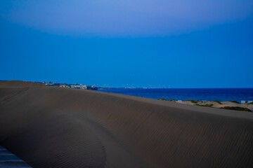Fototapeta na wymiar Sunset, Moon and Evening Sky over Maspalomas on Gran Canary Island Spain.