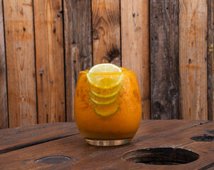 Cocktail. Closeup view of a tropical passion fruit daiquiri with lime and a rustic wooden background