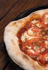 Closeup view of a traditional Neapolitan pizza with mozzarella cheese, roasted garlic, sliced...