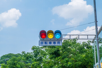 Japanese traffic lights and sign above scramble crossing in front of Tokyo station ,Japanese under the traffic light means "push button type.