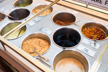 Close up of the half soup base steamboat with Mala soup and raw pork slices,Fresh vegetables prepared for Chinese shabu .