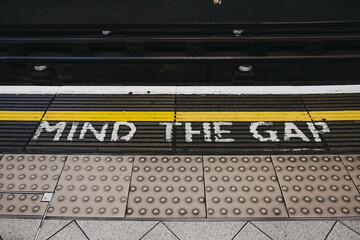 Mind the gap sign an a platform an underground station, London, UK.
