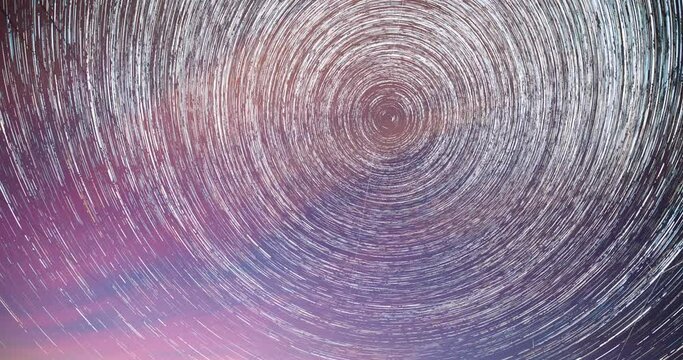 Trails Of Stars Rotate Above Power Line. 4k Hyperlapse Night Starry Sky. Dawn Is Coming. Daybreak Sky. Soft Blue-orange-pink Colours. Spin Trails Of Stars On Night Sky Background. Unusual Amazing