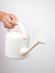 Composition with a watering can in hand. Spring mock up. Gardening concept. Front view. © Gizelly