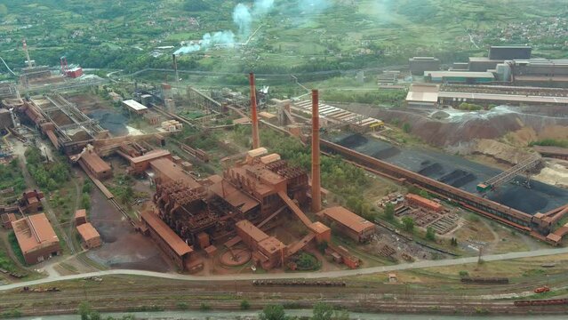 Drone Shot of an Old Iron Factory by a River. Concept of Environmental Conservation, life expectancy, industrial pollution. Zenica, Bosnia and Herzegovina