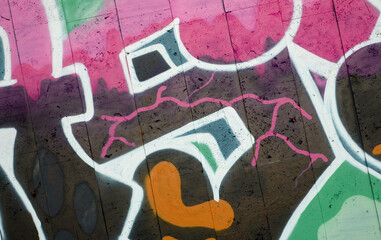 Colorful background of graffiti painting artwork with bright aerosol outlines on wall. Old school...
