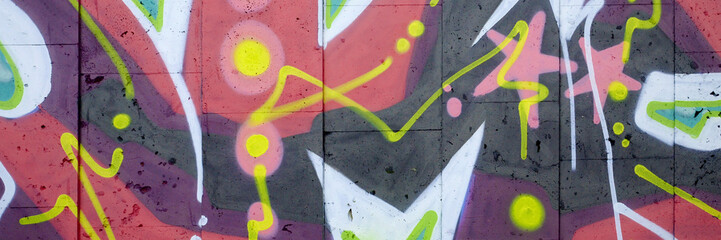 Colorful background of graffiti painting artwork with bright aerosol outlines on wall. Old school...