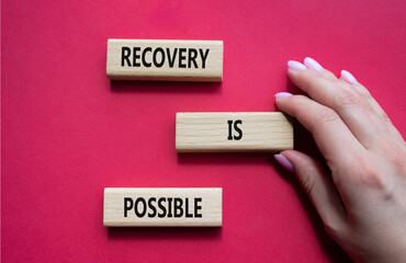 Recovery is possible symbol. Concept words Recovery is possible on wooden blocks. Beautiful red...