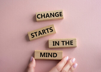 Change starts in the mind symbol. Concept words Change starts in the mind on wooden blocks. Beautiful pink background. Businessman hand. Business and Change starts in the mind concept. Copy space