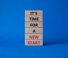 Time for a new start symbol. Wooden blocks with words Time for a new start. Beautiful blue...
