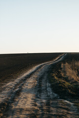 a dirt road in the field that leads to nowhere