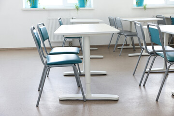 Empty school classroom with desks and chairs