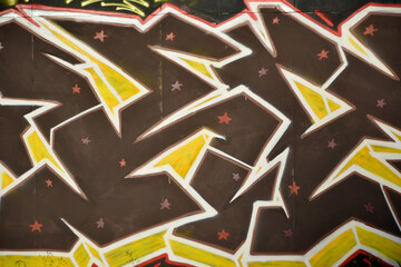 Colorful background of graffiti painting artwork with bright aerosol outlines on wall. Old school...