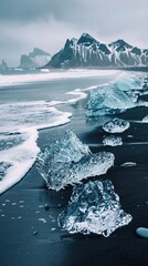 Ice pieces on black sand beach against mountains