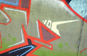 Colorful background of graffiti painting artwork with bright aerosol outlines on wall. Old school street art piece made with aerosol spray paint cans. Contemporary youth culture backdrop