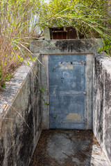 Heavy steel door protecting abandoned underground bunker