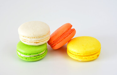 four different colored macarons are next to each other on white background  