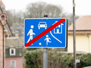End of a living street sign in a residential district. Traffic symbol when leaving an area with playing children on the road. The speed limit zone is over.