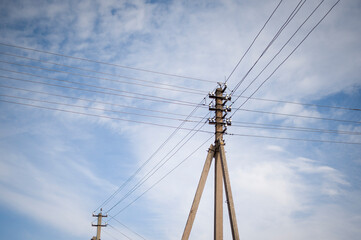Fototapeta premium Old style electricity line with old equipment on blue sky background