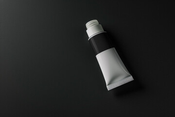 A single minimalist cosmetic cream tube against a deep black isolated solid background, emphasizing the product's elegance,
